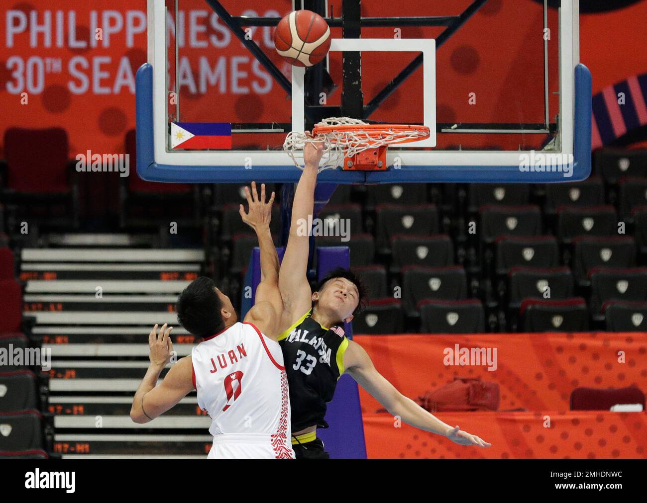 Malaysian Xian Fu Ooi, right, tries to block the shot of Indonesian ...