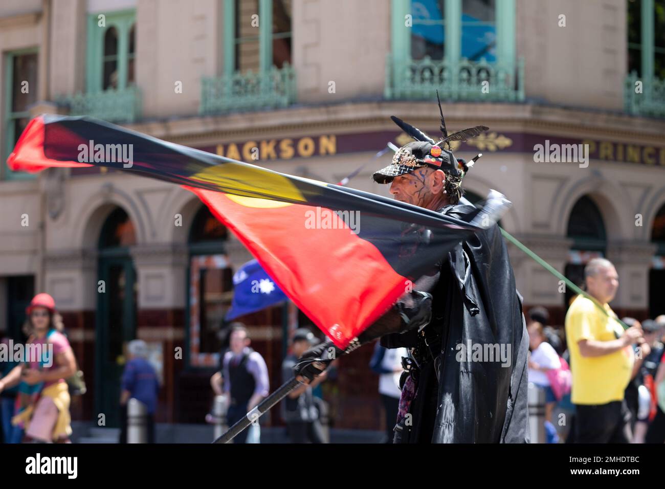 Melbourne, Australia, 26 January, 2023. An indigenous activist dressed in an elaborate costume is seen twirling an Aboriginal Flag during the annual Invasion Day protest in Melbourne, organized by Indigenous Australians and their allies, calls for an end to the celebration of Australia Day and for the recognition of Indigenous sovereignty. Credit: Dave Hewison/Alamy Live News Stock Photo