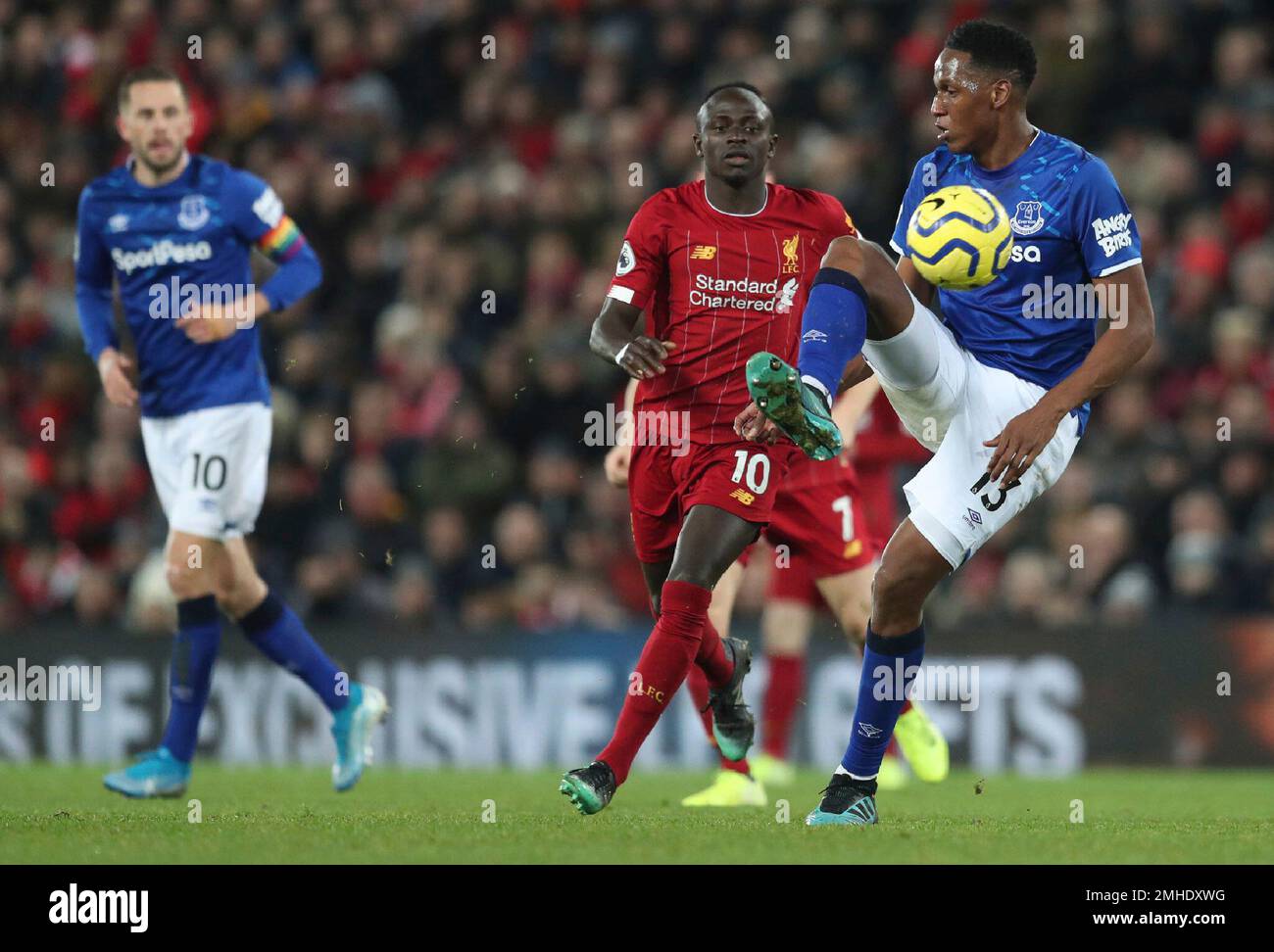 Everton's Yerry Mina, right, controls the ball by Liverpool's Sadio
