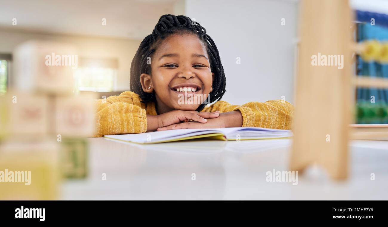 Education, child and girl writing at table for homework, lesson and home school activity in her house. Learning, student and child development Stock Photo