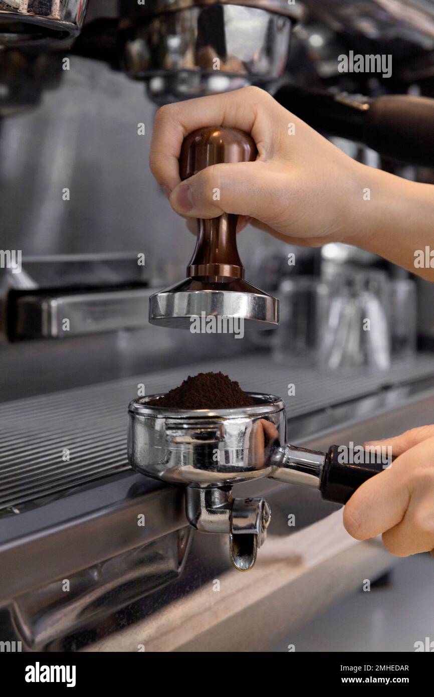 barista tamping coffee in cafe Stock Photo Alamy