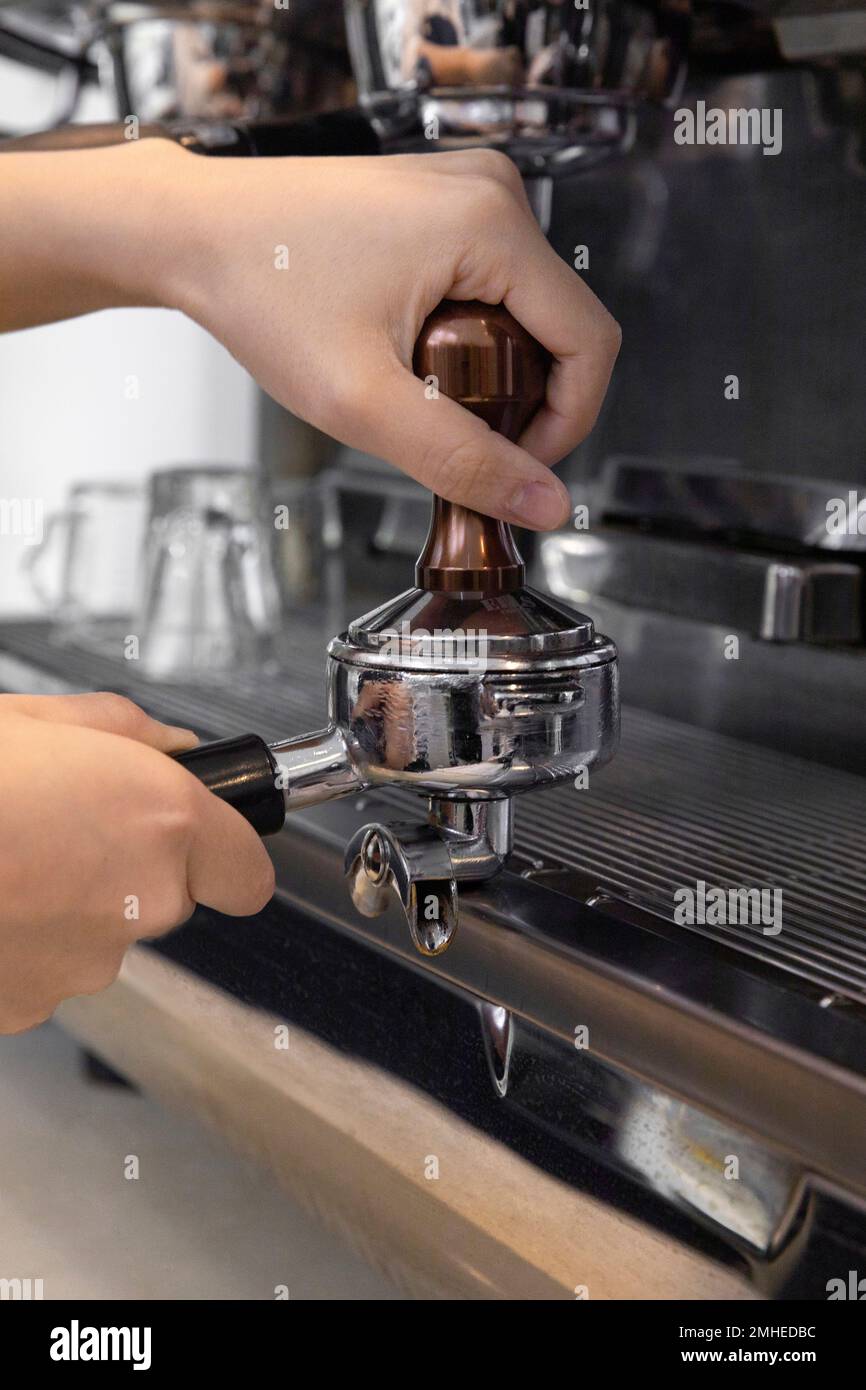 barista tamping coffee in cafe Stock Photo Alamy