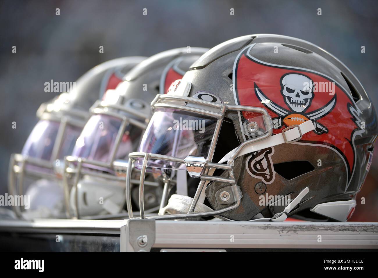 Baltimore Ravens helmets sit behind players on the bench during