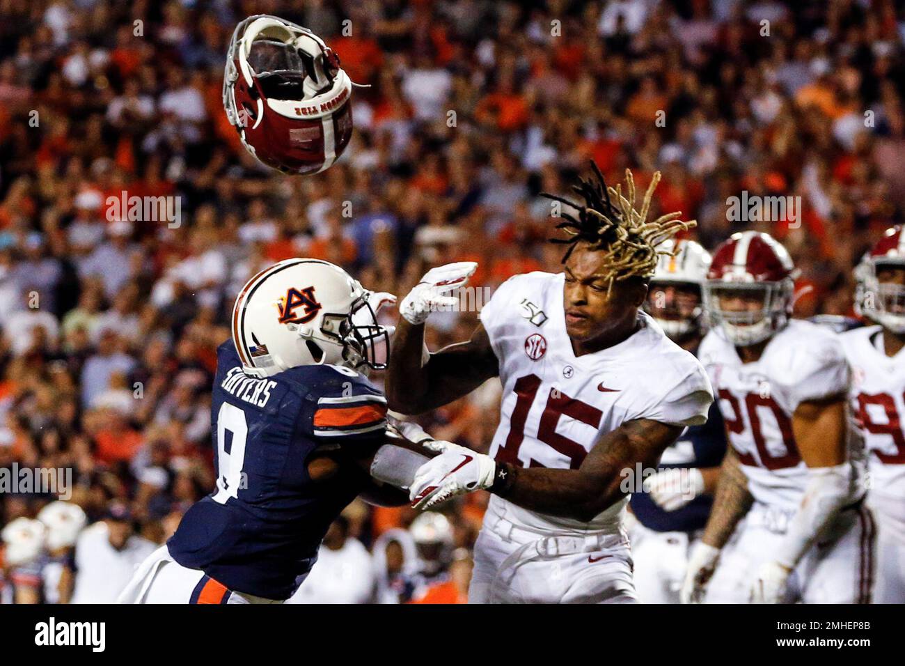 Alabama defensive back Xavier McKinney (15) loses his helmet as Auburn  running back Shaun Shivers (8) runs through him for a touchdown during the  second half of an NCAA college football game