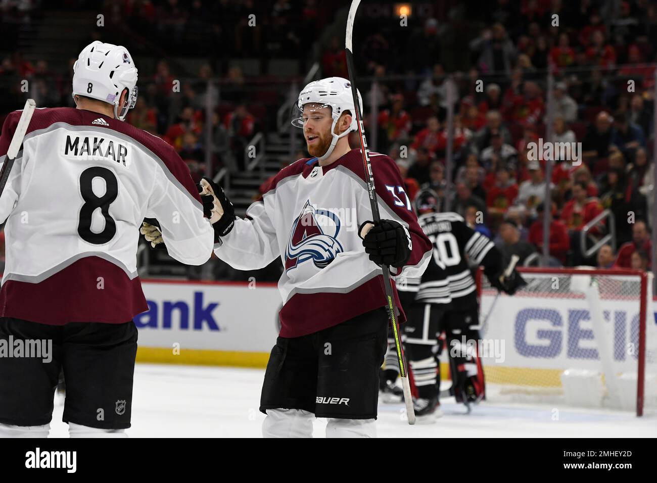 Colorado Avalanche defenseman Cale Makar (8) and left wing J.T. Compher  (37) acknowledge fans and family in the stands after the team won the  Stanley Cup by defeating the Tampa Bay Lightning in Game 6 of the NHL  hockey Stanley Cup Finals on