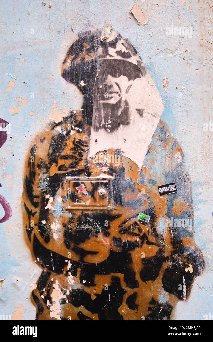 A soldier, fighter, armed forces member, in a camouflage uniform. An example of graffiti in Naples, Napoli, Italy, Italia. Stock Photo