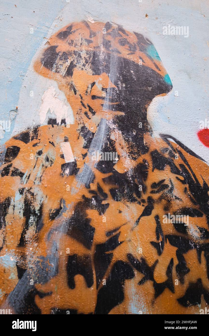 A soldier, fighter, armed forces member, in a camouflage uniform. An example of graffiti in Naples, Napoli, Italy, Italia. Stock Photo