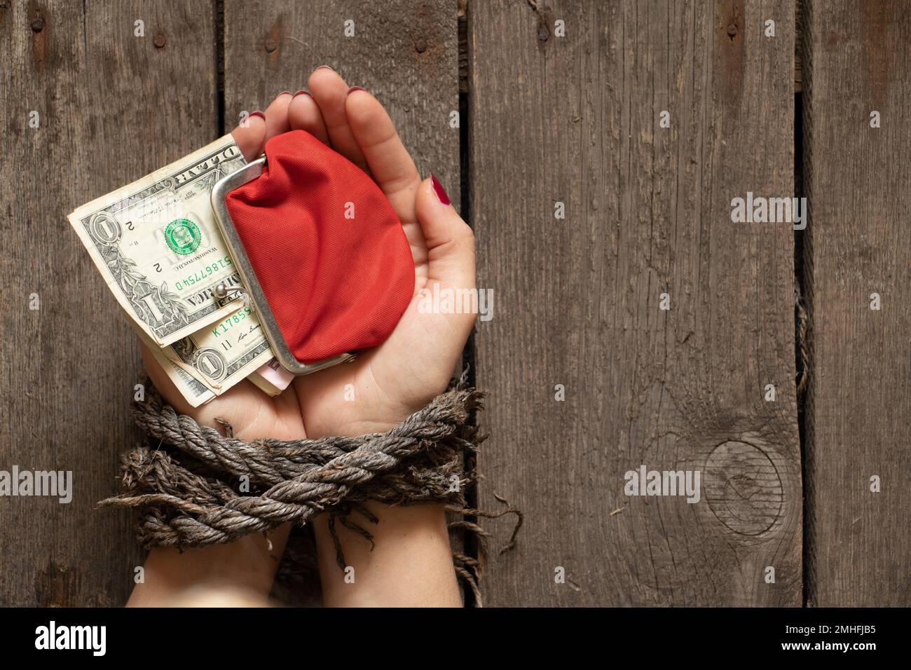 Girl in handcuffs and mask. in color lights. tied hands and