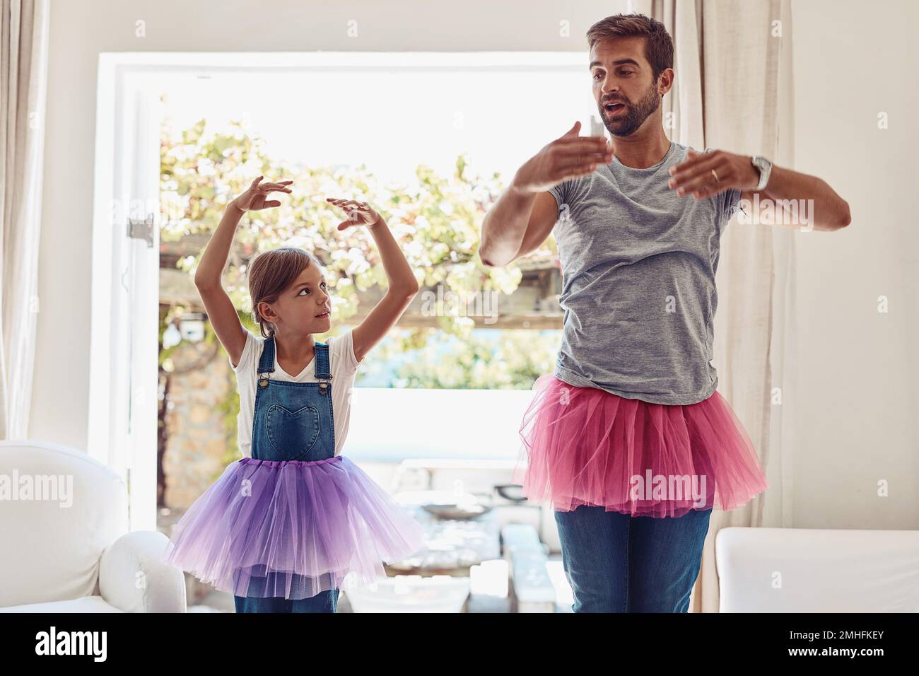 Oh, its all about the arms, I see...a father and daughter dancing in their tutus. Stock Photo