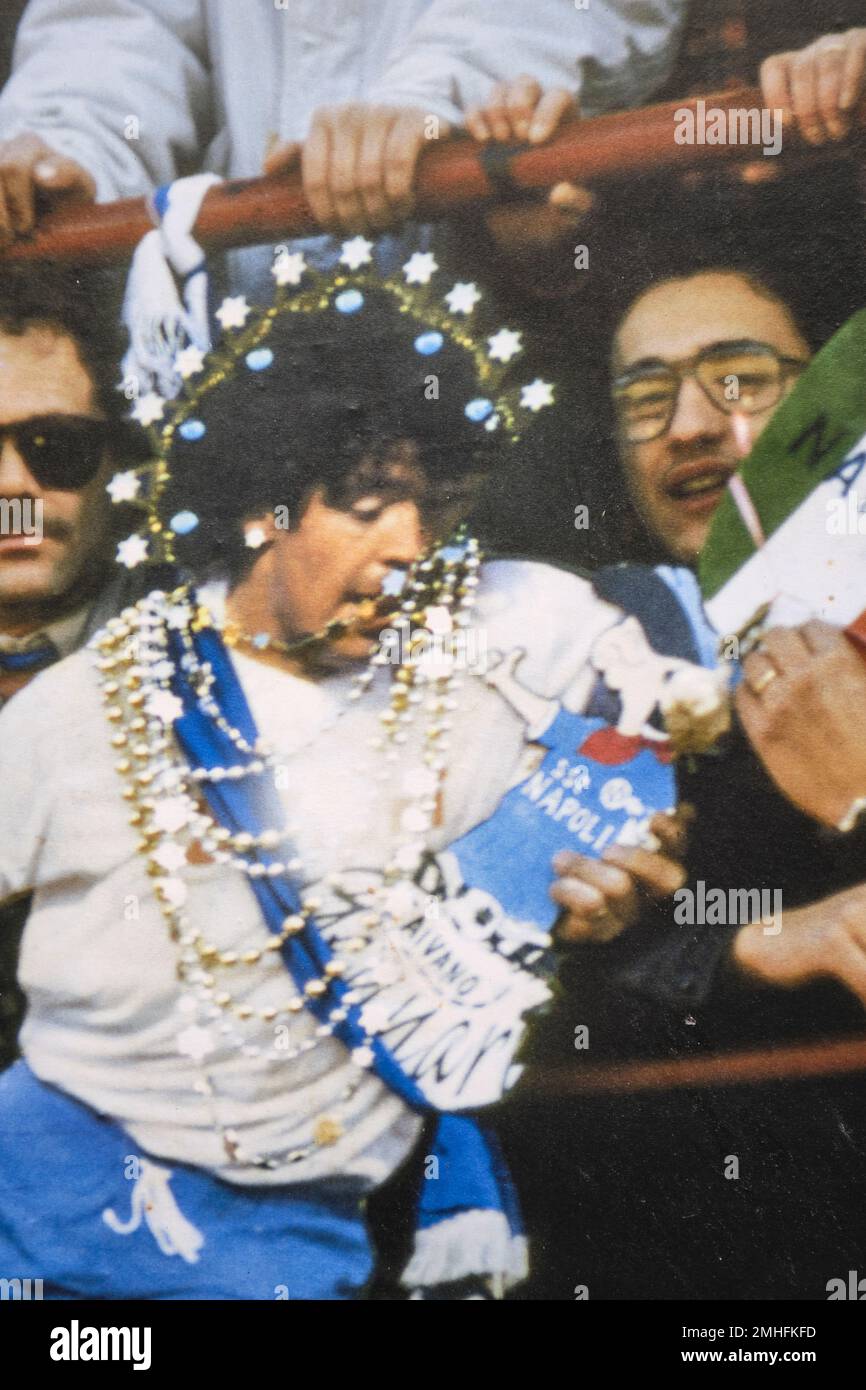 A picture of footballer, soccer star Diego Maradona, with a golden necklace added. An example of graffiti in Naples, Napoli, Italy, Italia. Stock Photo
