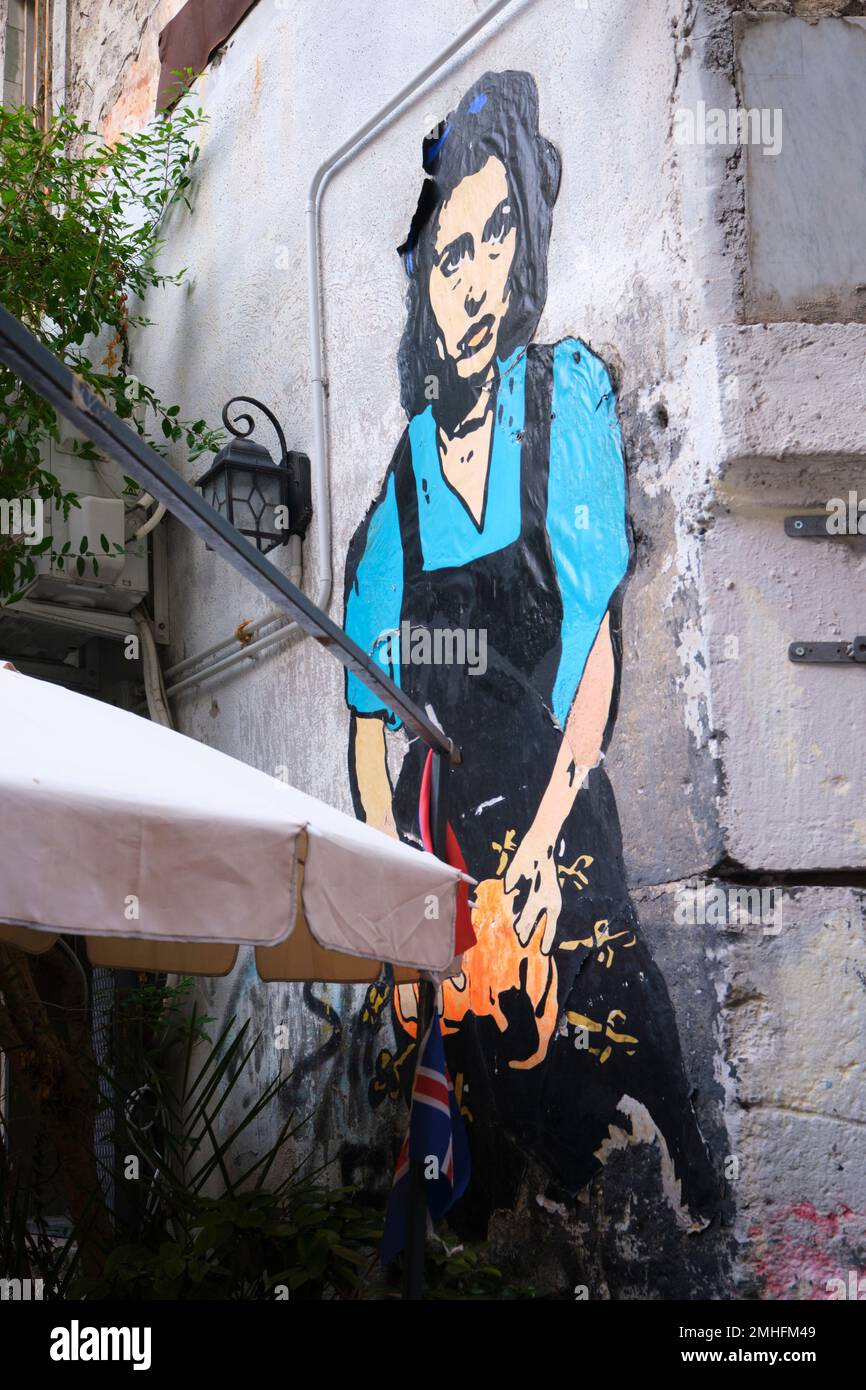 A large painted paper poster for legendary, iconic Italian movie star, Sophia Loren, in an apron. An example of graffiti in Naples, Napoli, Italy, Ita Stock Photo