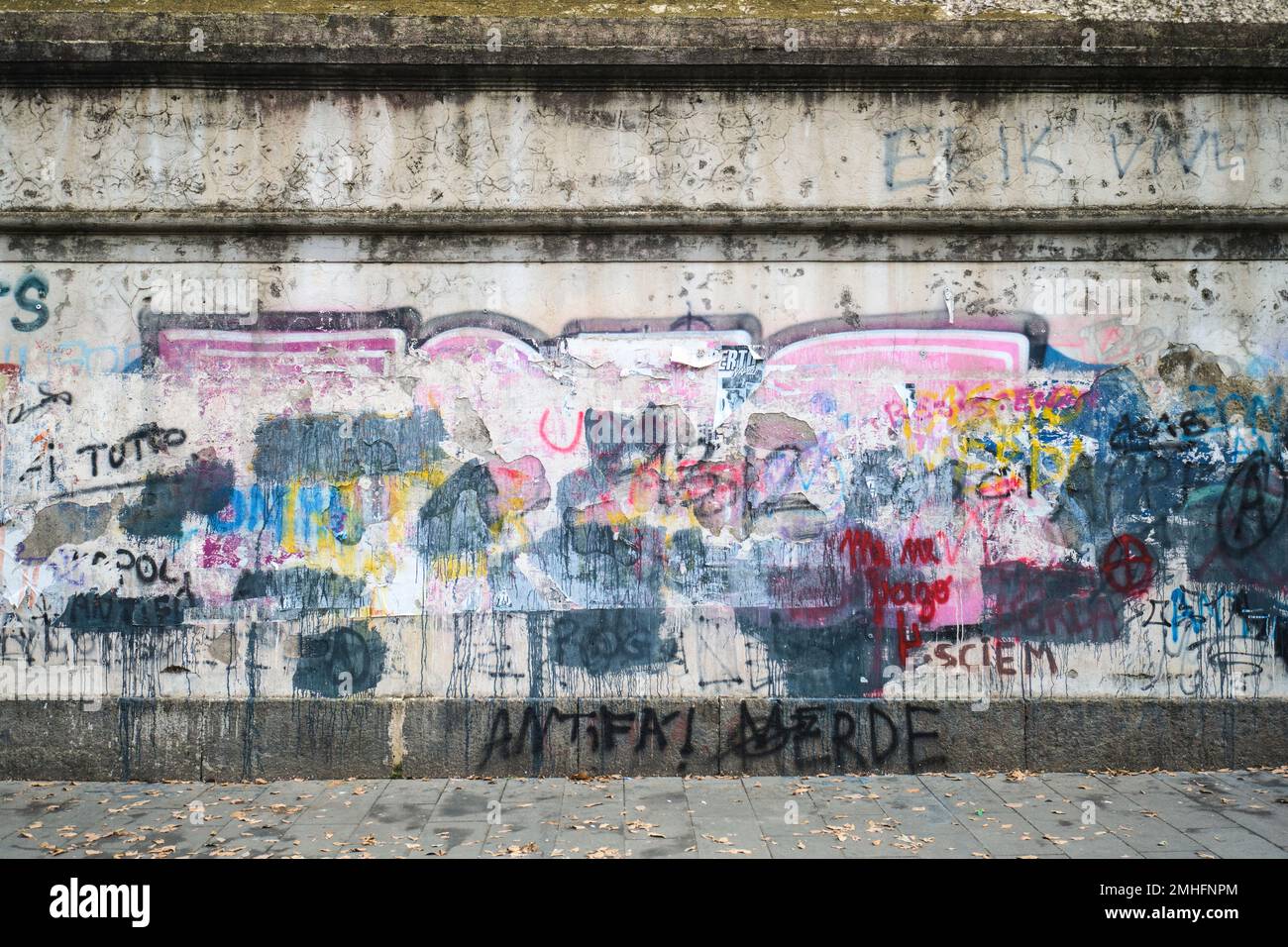 The exterior wall of the Caserma Garibaldi army barracks, covered in tagged words, messy layers. An example of graffiti in Naples, Napoli, Italy, Ital Stock Photo