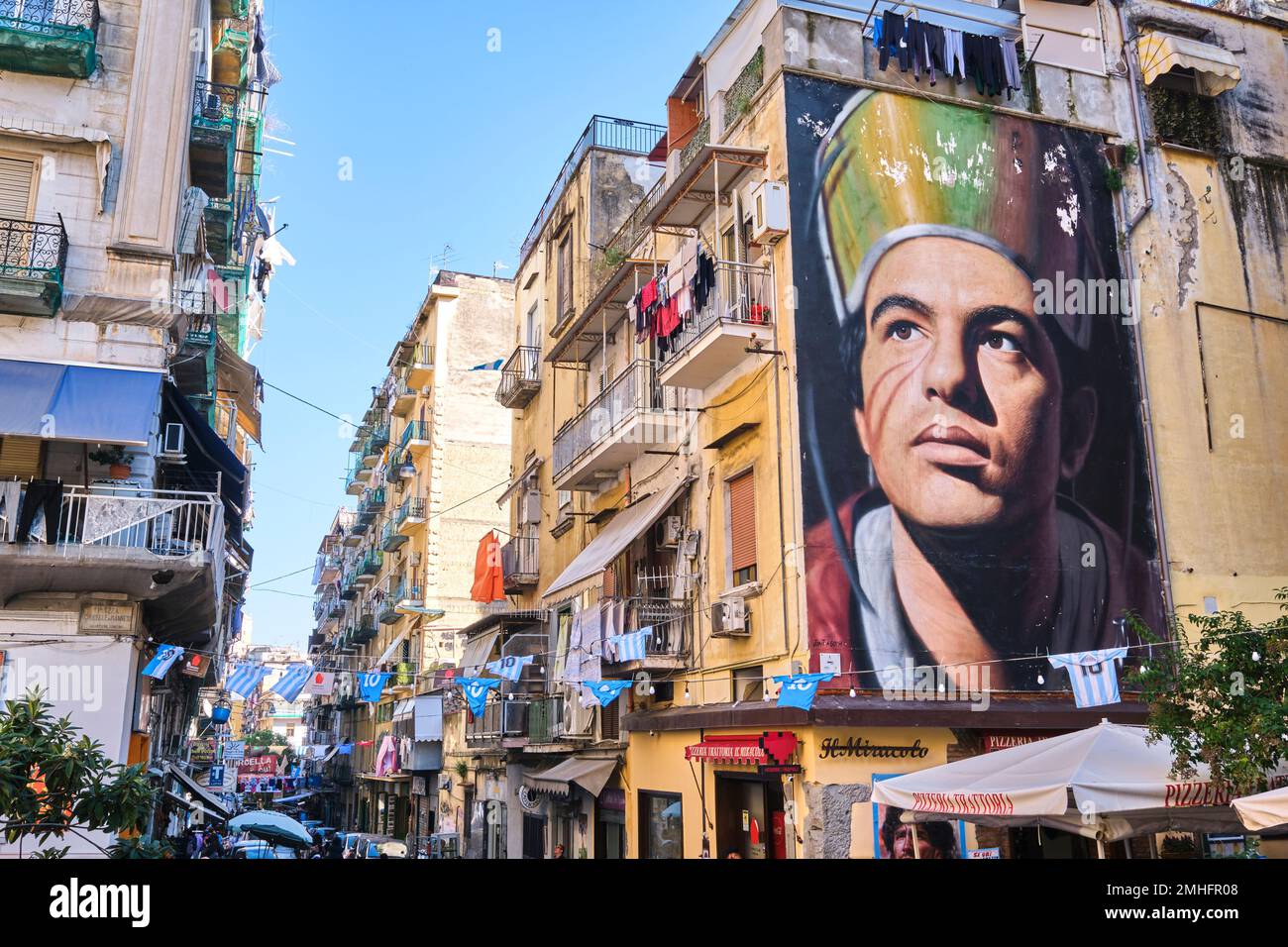 A huge mural in the Forcella neighborhood by artist Jorit Agoch. It depicts the city's patron saint, Gennaro, as a young factory worker, similar to a Stock Photo