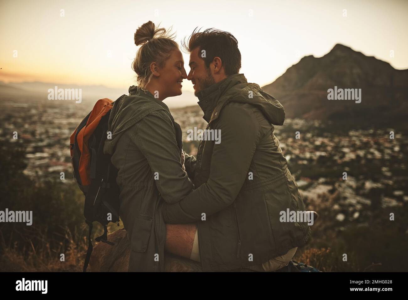 Find your adventurous match. an affectionate couple on a mountain top. Stock Photo