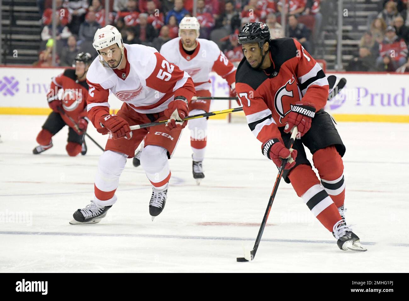 New Jersey Devils right wing Wayne Simmonds (17) controls the puck as he is  pursued by Detroit Red Wings defenseman Jonathan Ericsson (52) during the  second period of an NHL hockey game