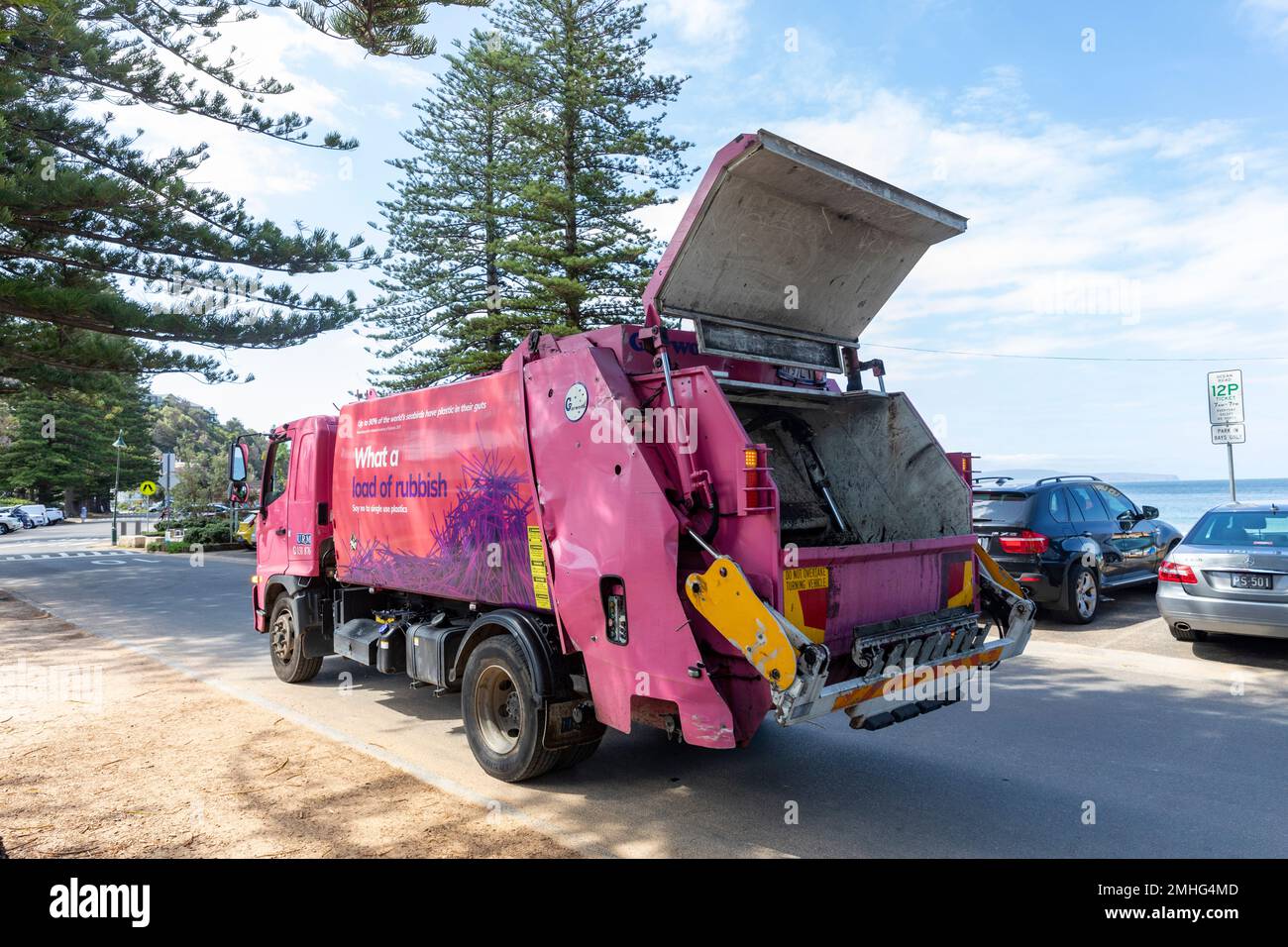 Garbage rubbish collection truck at Palm Beach Sydney collecting waste from public street bins