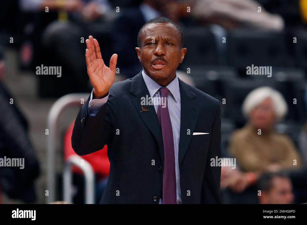Detroit Pistons head coach Dwane Casey signals from the bench during