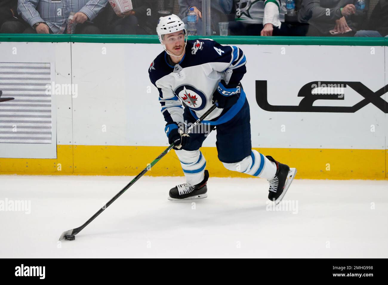 Winnipeg Jets defenseman Neal Pionk (4) controls the puck during an NHL