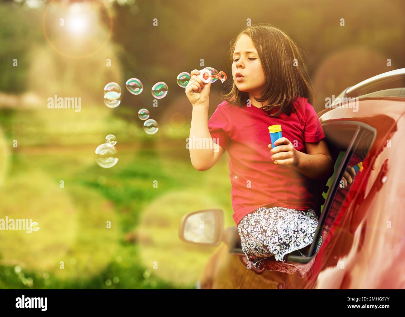 Bubbles make everything better. a playful little girl blowing bubbles