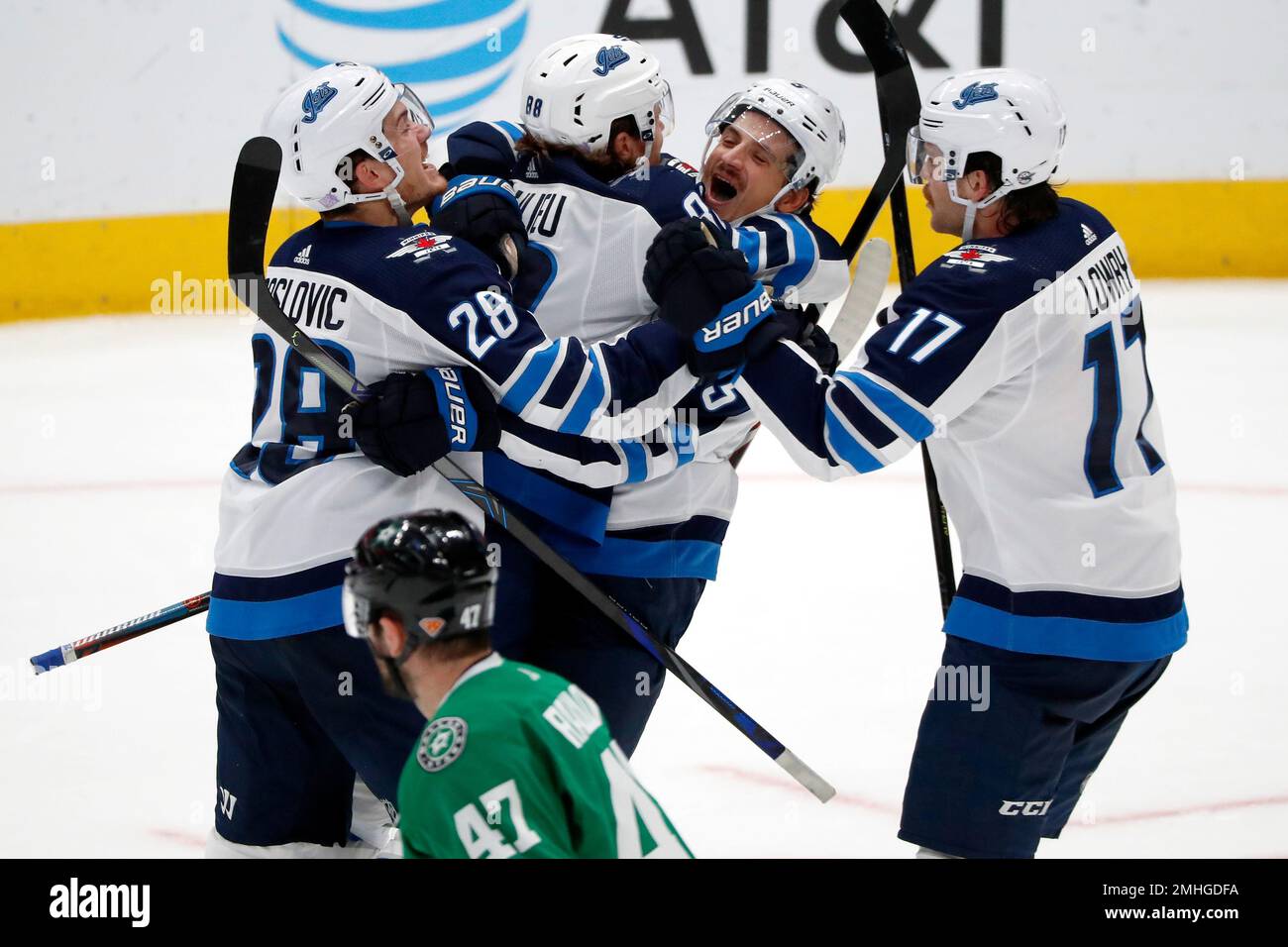 Winnipeg Jets' Adam Lowry (17) and Chicago Blackhawks' Jarred Tinordi (25)  fight during the third period