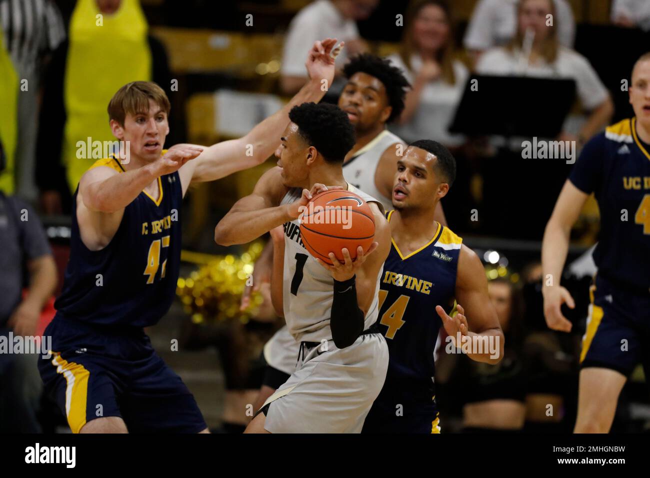 Colorado guard Tyler Bey, center, loses control of the ball after UC Irvine  guard Evan Leonard, right, attempted a steal as UC Irvine forward Tommy  Rutherford covers in the first half of