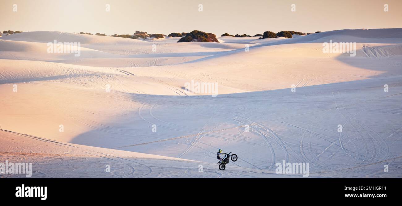 Desert, motorcycle and athlete doing a sport jump for outdoor