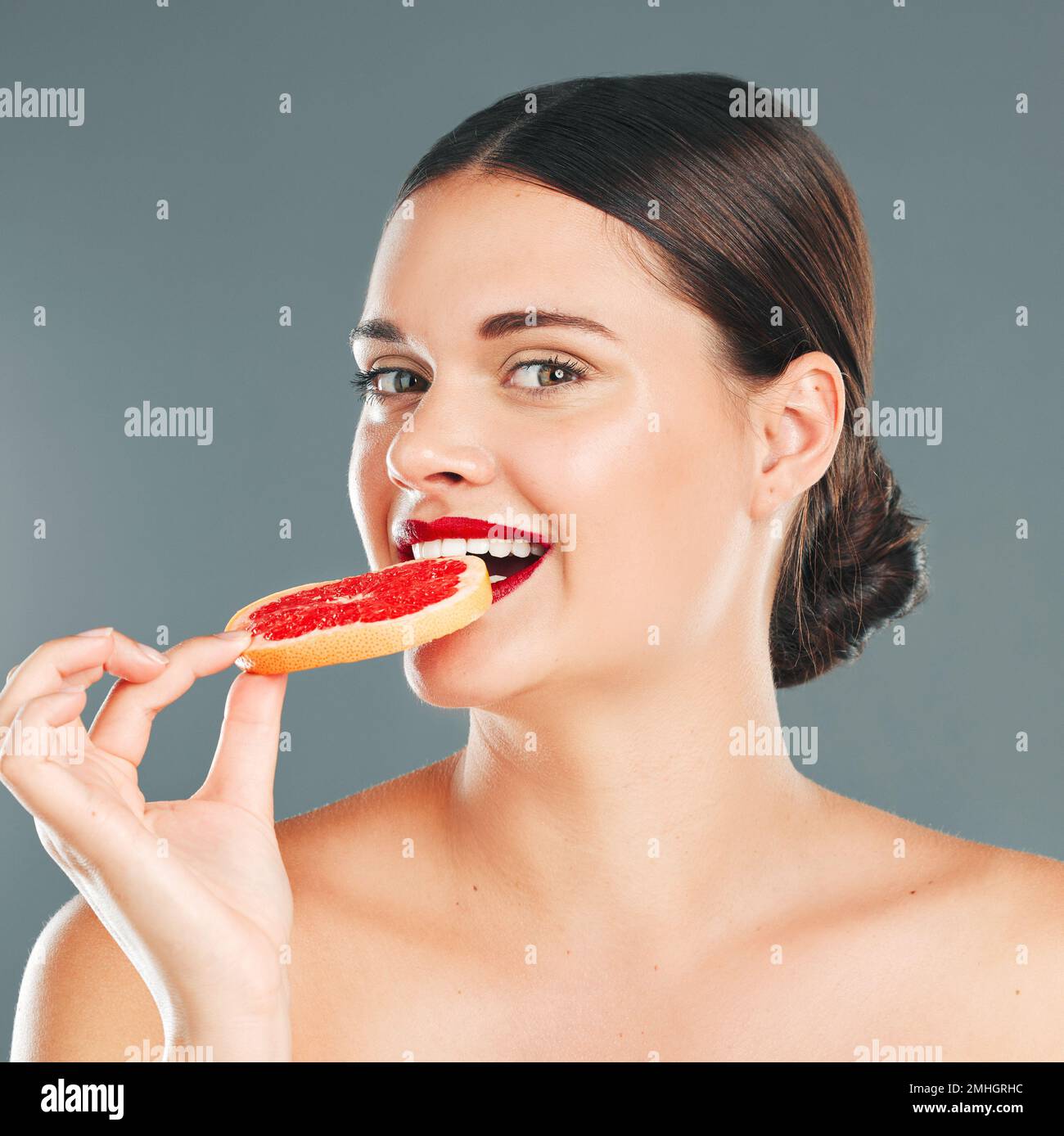 Fruit bite, portrait and woman eating a grapefruit for nature and ...