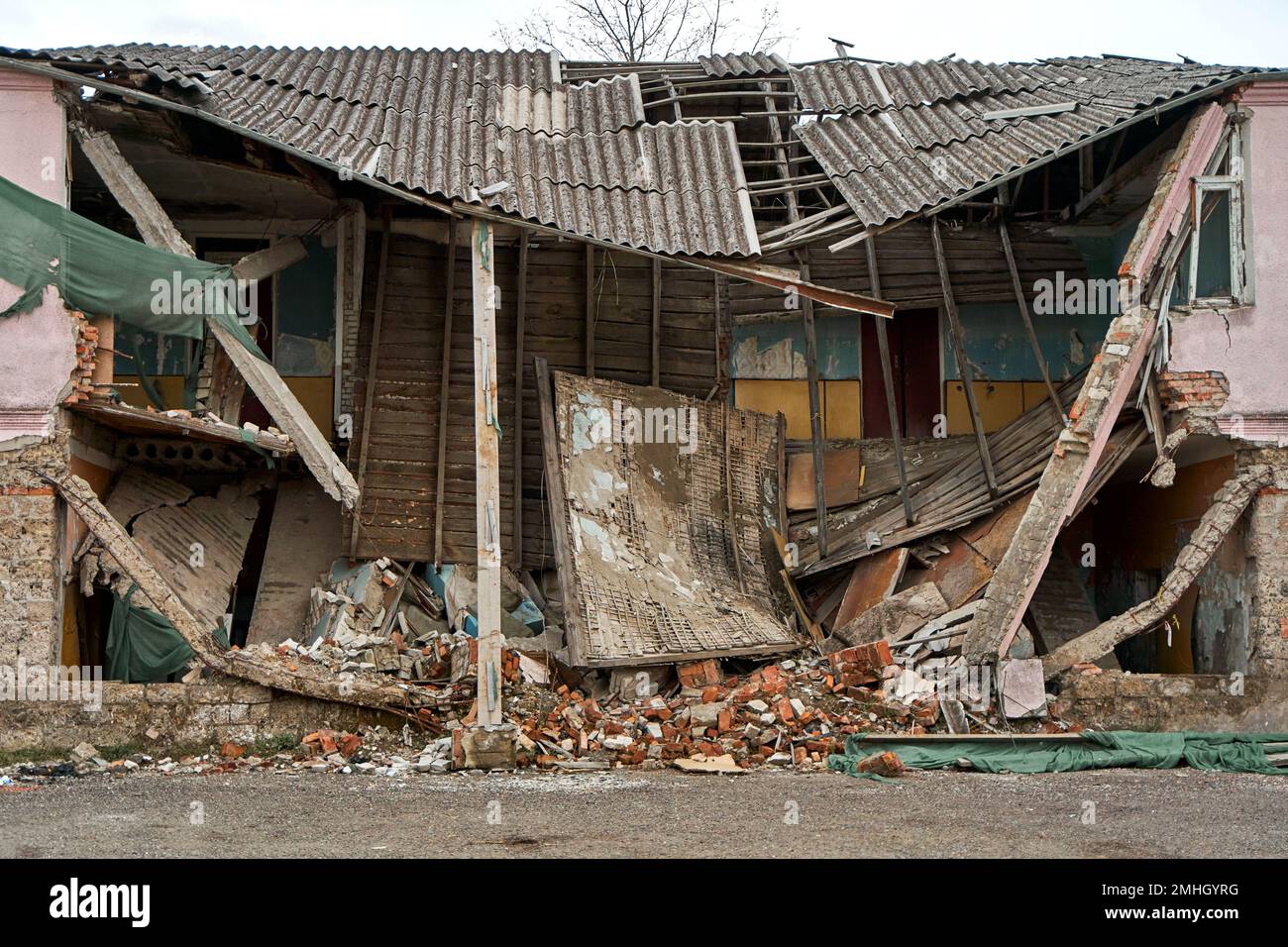 An abandoned two-story building with a crumbling roof Stock Photo - Alamy