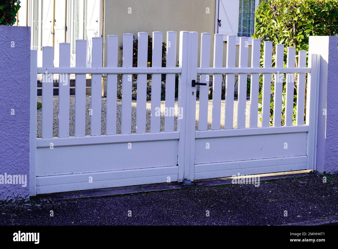 white classic home door aluminum gate slats portal garden entry suburb house Stock Photo