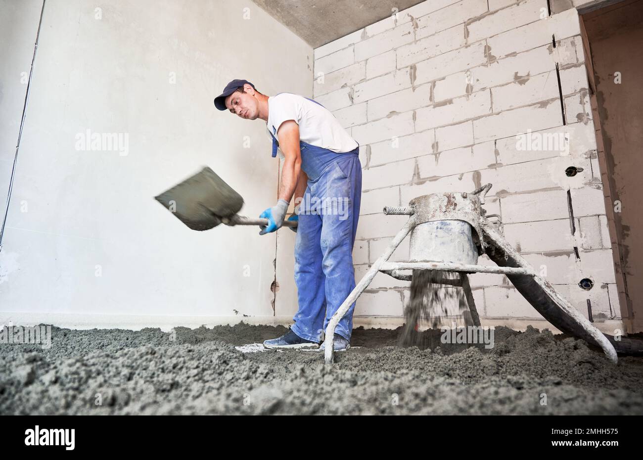 Man preparing cement with shovel hi-res stock photography and 