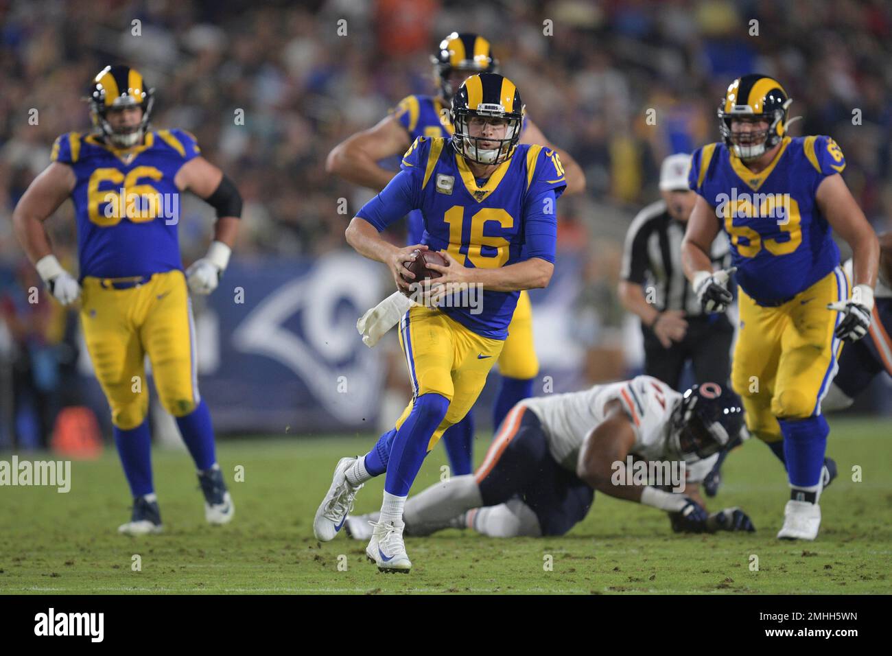 Los Angeles Rams quarterback Jared Goff, center, escapes from Chicago