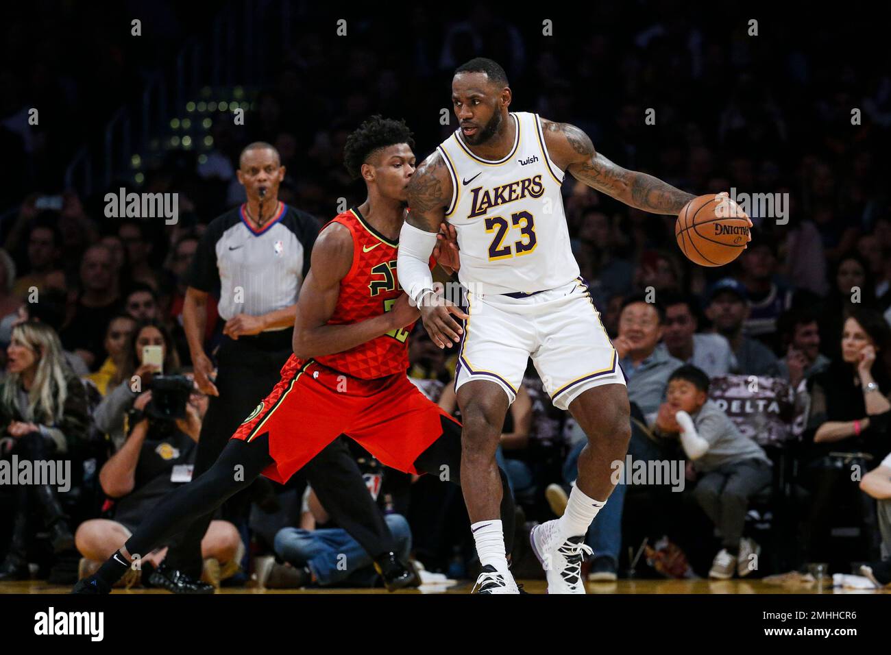 Los Angeles Lakers LeBron James 23 dribbles against Atlanta Hawks s Cam Reddish 22 during the second half of an NBA basketball game Sunday Nov. 17 2019 in Los Angeles. The Lakers won