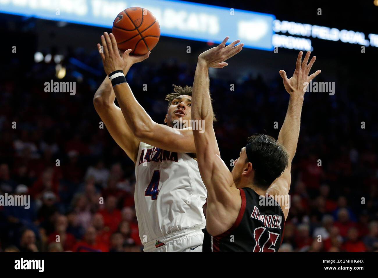 Arizona center Chase Jeter (4) shoots over New Mexico State forward Ivan  Aurrecoechea in the second