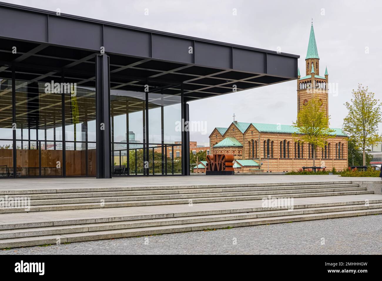 The New National Gallery designed by Ludwig Mies van der Rohe and St. Matthew's Church, both part of the Kulturforum Berlin. Stock Photo