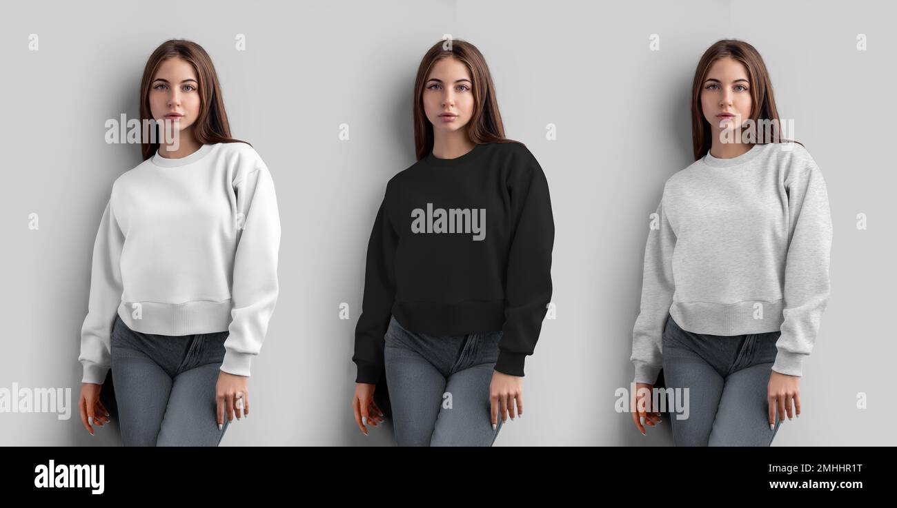 Mockup of a white, black, heather crop sweatshirt on a girl, women's shirt for design, isolated on a wall background, front view. Fashion casual cloth Stock Photo