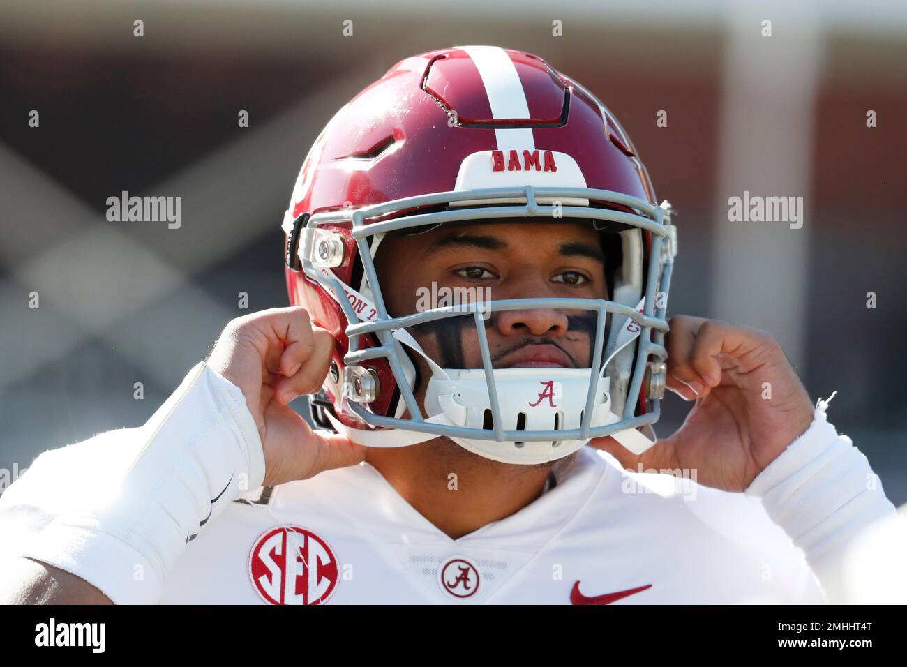 Alabama quarterback Tua Tagovailoa (13) adjusts his helmet before the first  half of an NCAA college football game against Mississippi State in  Starkville, Miss., Saturday, Nov. 16, 2019. Tagovailoa was injured in
