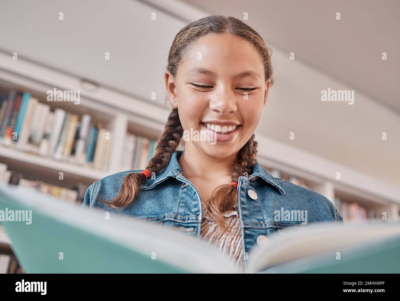 Books, library or happy student reading a fun story for knowledge or