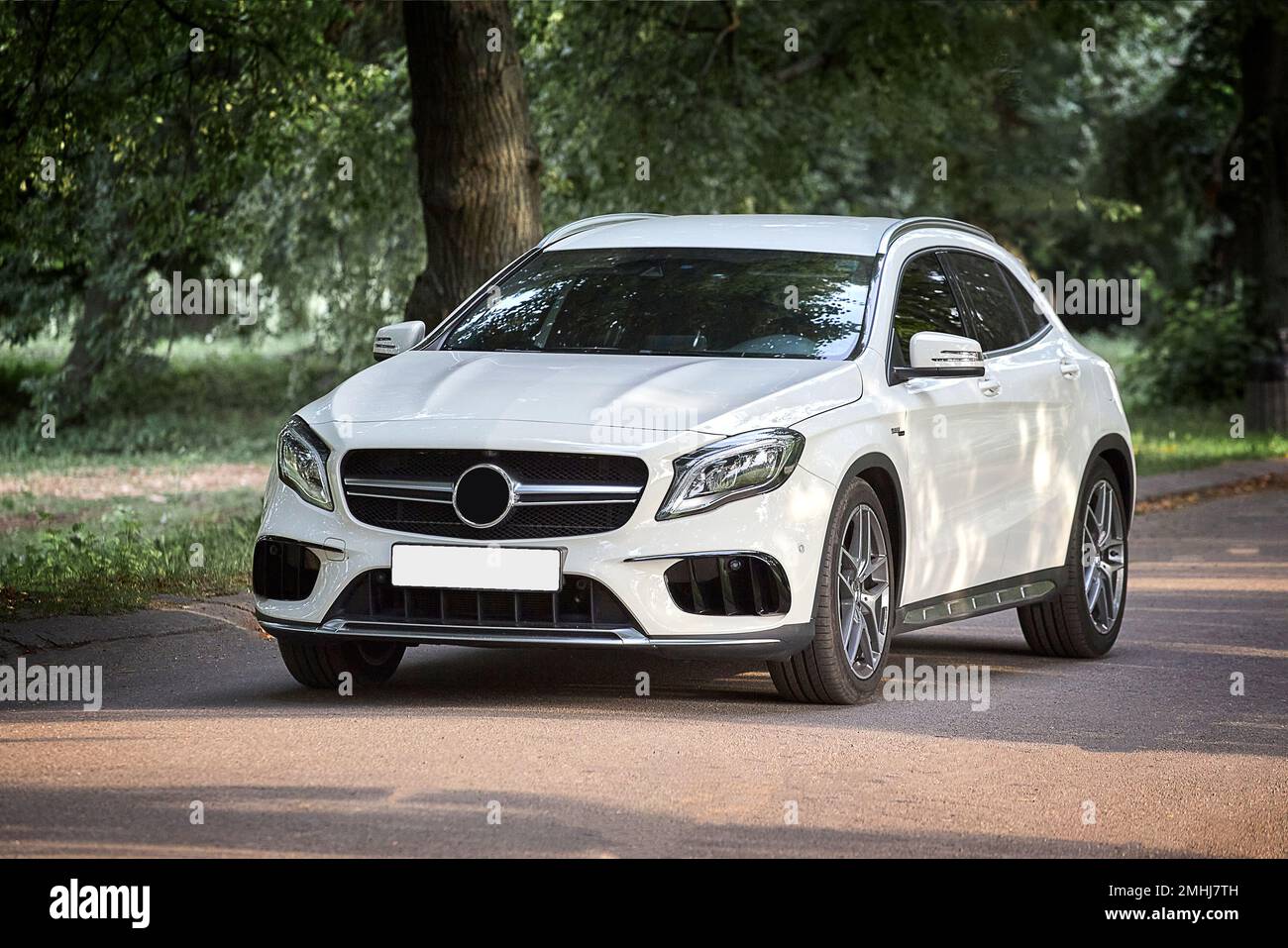 Modern white car driving in the country side background, luxury city
