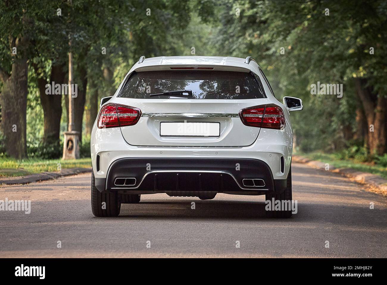 Modern white car driving in the country side background, luxury city