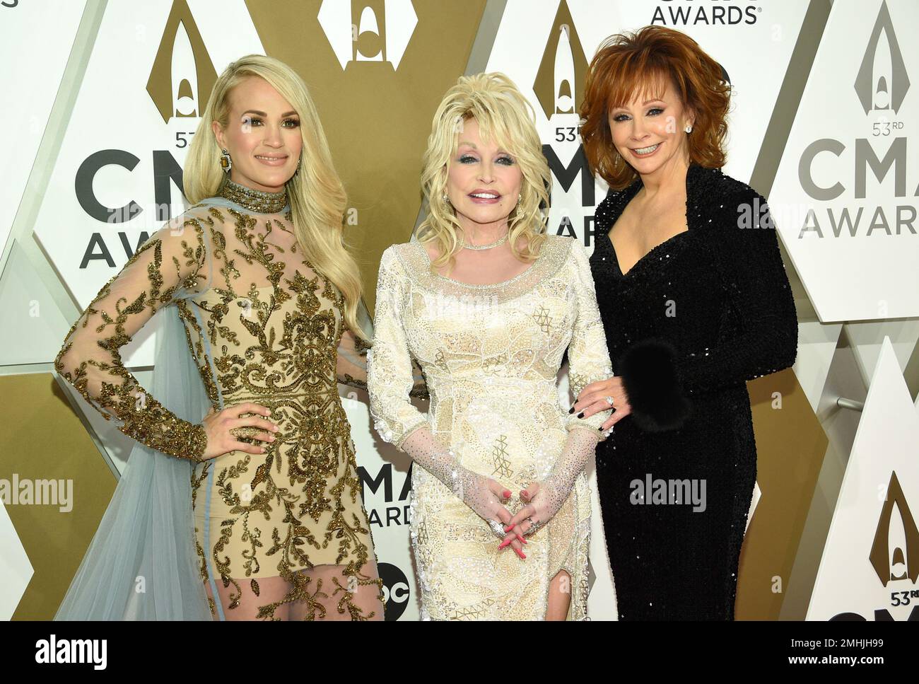 Carrie Underwood, from left, Dolly Parton, and Reba McEntire arrive at