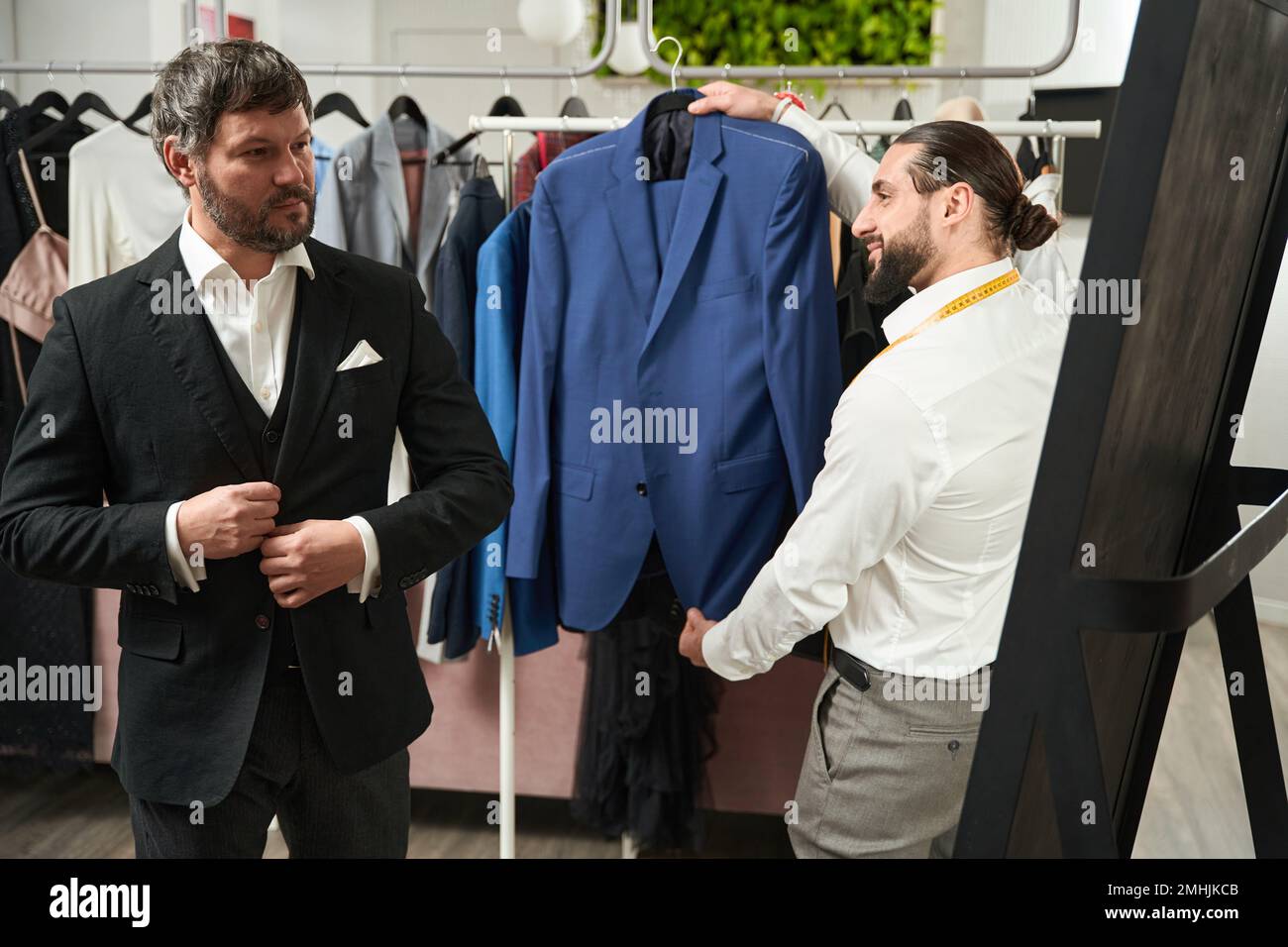 Man checking fit of custom-tailored suit in atelier Stock Photo - Alamy