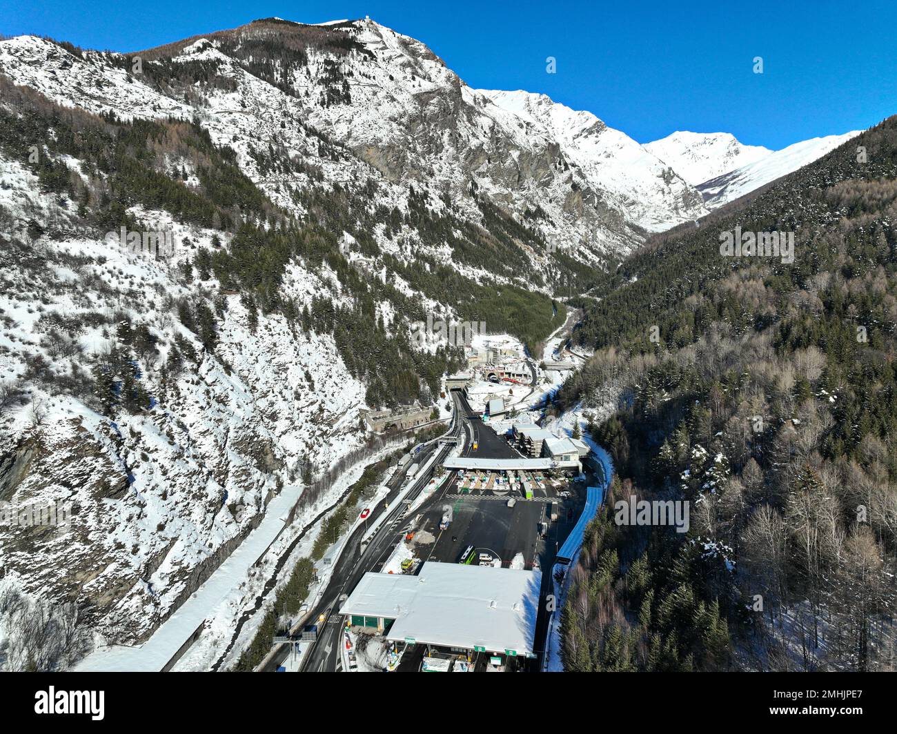 Winter aerial view of Frejus motorway tunnel under the Alps on the border between France and Italy.  Bardonecchia, Italy - January 2023 Stock Photo