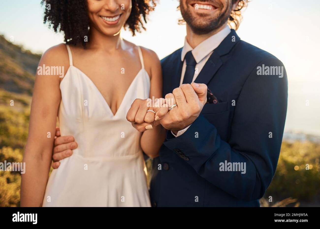 Pink promise, marriage and wedding couple hands together outdoor for trust, love and care. Support, solidarity and agreement in nature at intimate Stock Photo