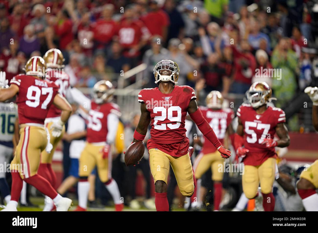 Green Bay Packers running back Aaron Jones (33) runs in front of San  Francisco 49ers cornerback Richard Sherman (25) and strong safety Jaquiski  Tartt (29) during the NFL football NFC Championship game