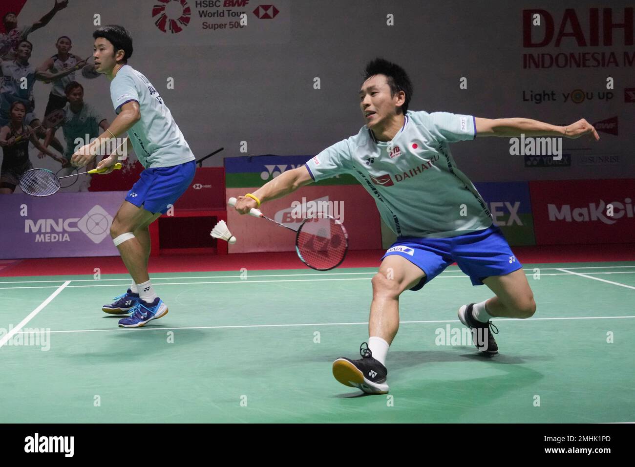 Indonesias Daniel Marthin, right, with Leo Rolly Carnando play against South Koreas Kang Min-hyuk and Seo Sung-jae during their mens doubles quarter final match at Indonesia Open badminton tournament at Istora Stadium