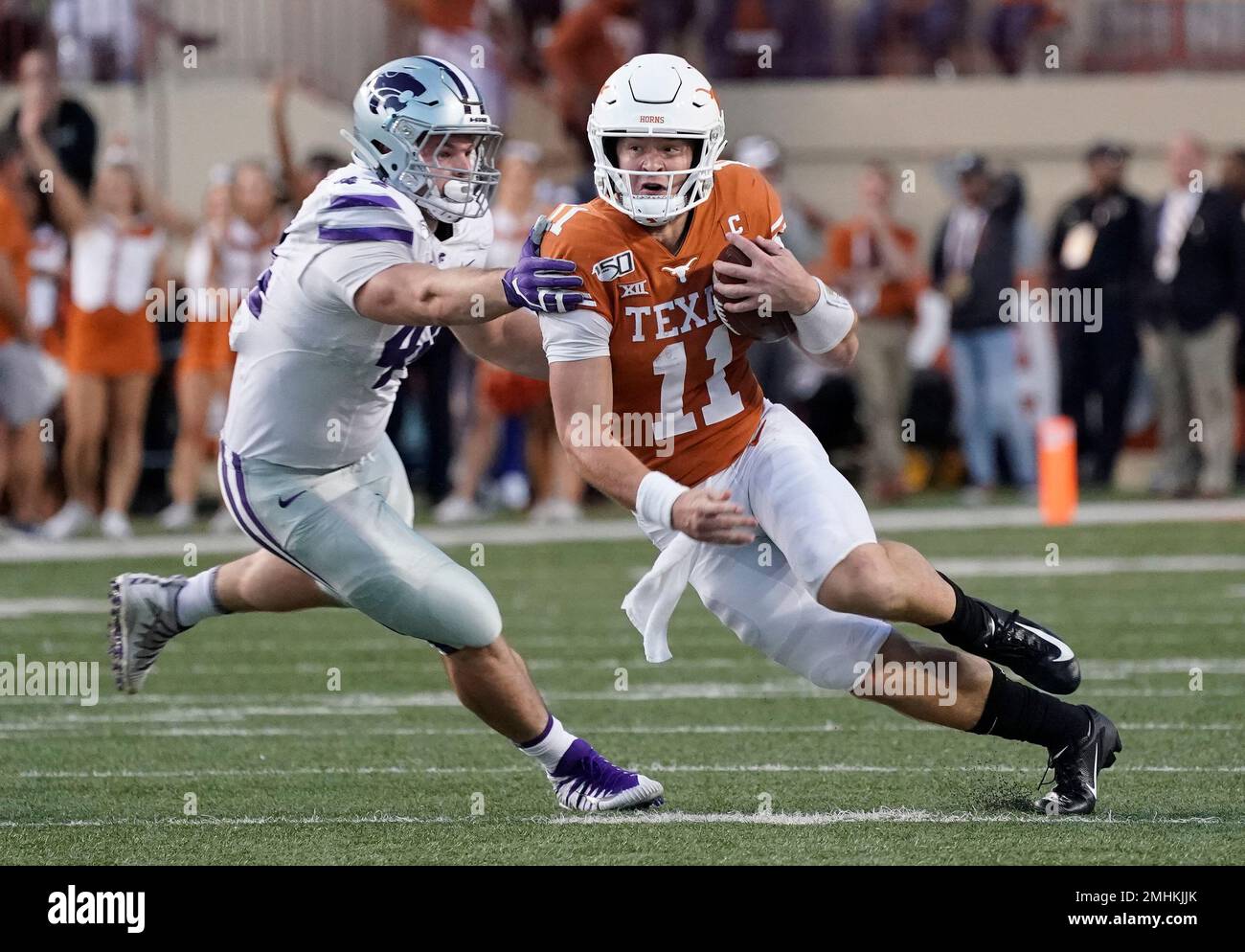 Texas' Sam Ehlinger (11) runs past Kansas State's Kyle Ball (44) during