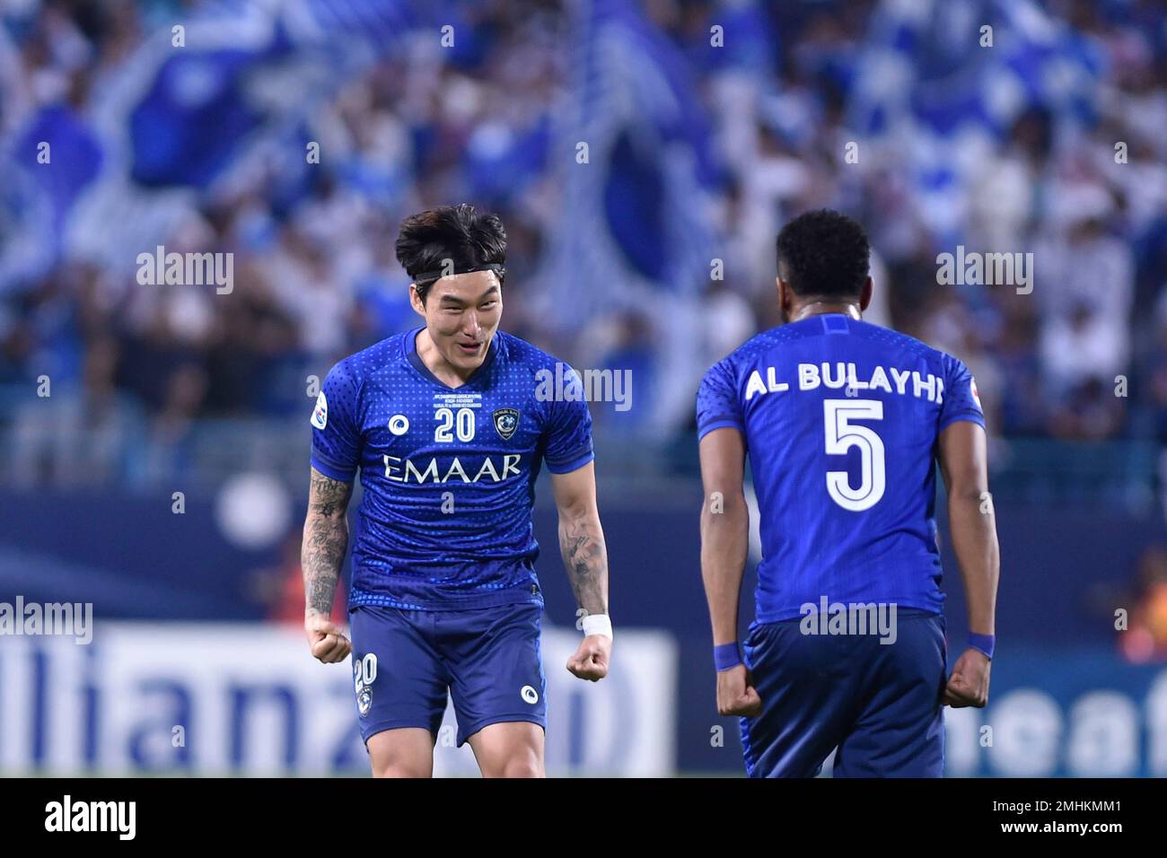 Al Hilal's Ali Al Bulayhi, right, fights for the ball with Urawa