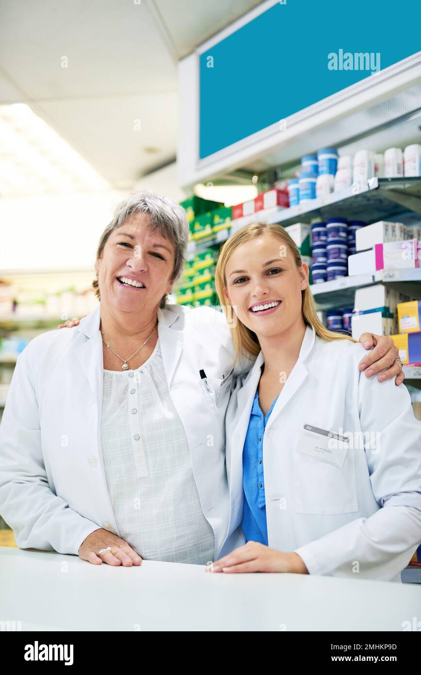 Stay well with our support. two happy women working together in a pharmacy. Stock Photo