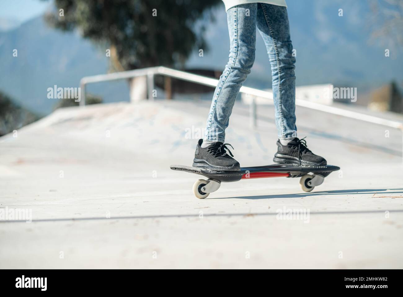 Legs on waveboard close up, Girl riding on casterboard with two wheels,  modern street skate sports of teenagers, ripstick for balance ride Stock  Photo - Alamy