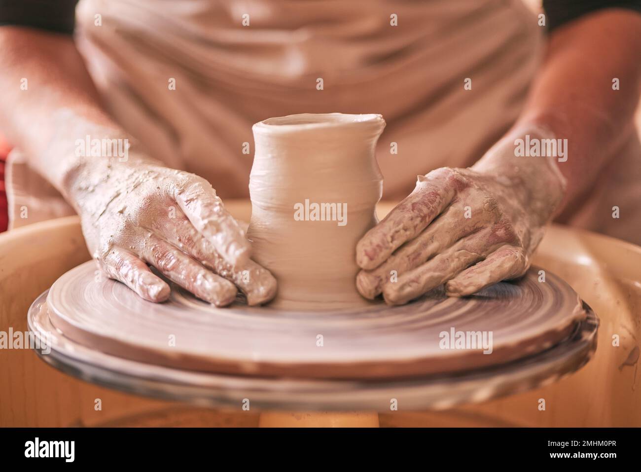 Hands, pottery and clay mold on table for creative art design, product